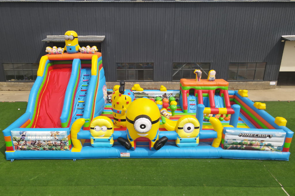 Minion-themed large inflatable playground fun city, shown during final testing before delivery. This commercial-grade inflatable features a slide, climbing wall, interactive obstacles, and themed characters, undergoing safety and quality inspection to ensure compliance with standards for amusement parks and event use.