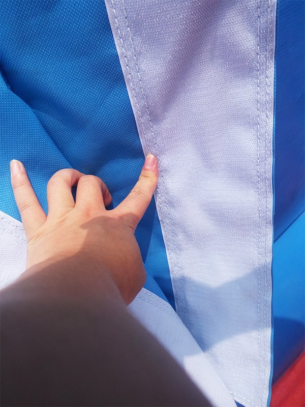 Close-up of reinforced multi-layer industrial stitching on inflatable PVC fabric, pressure-resistant reinforced seams for heavy commercial use