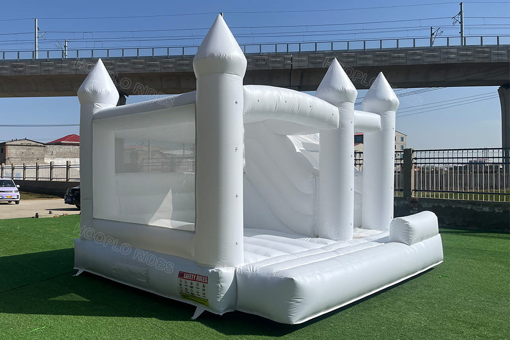 All white wedding bounce house left view - Clear mesh safety walls and spacious bouncing area for kids and adults