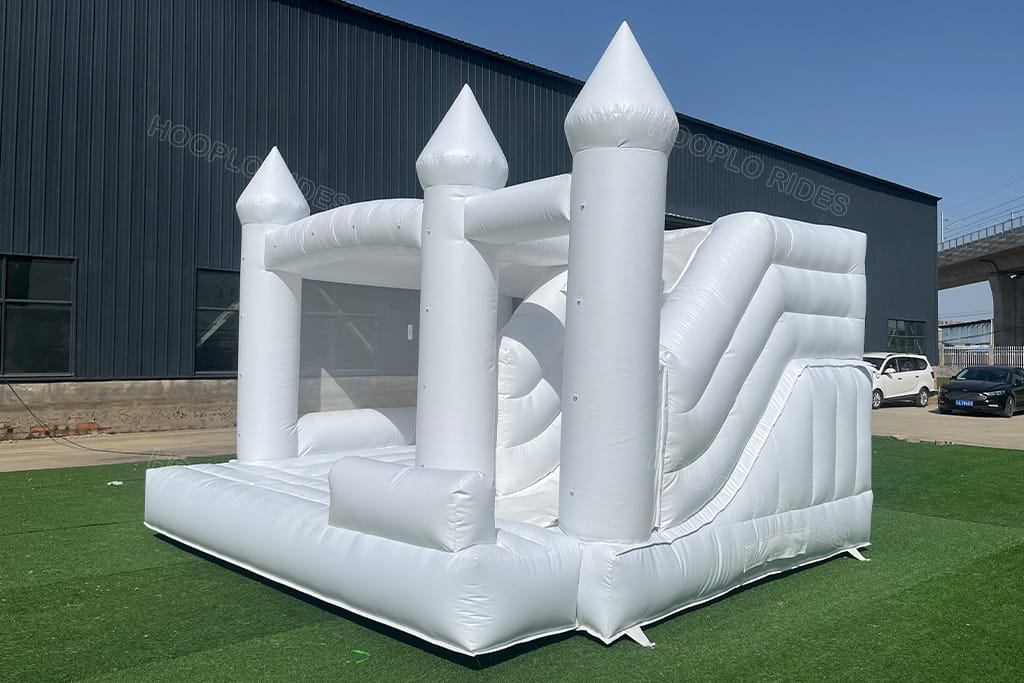 White inflatable wedding castle with slide right view - Durable commercial-grade PVC bounce house for events
