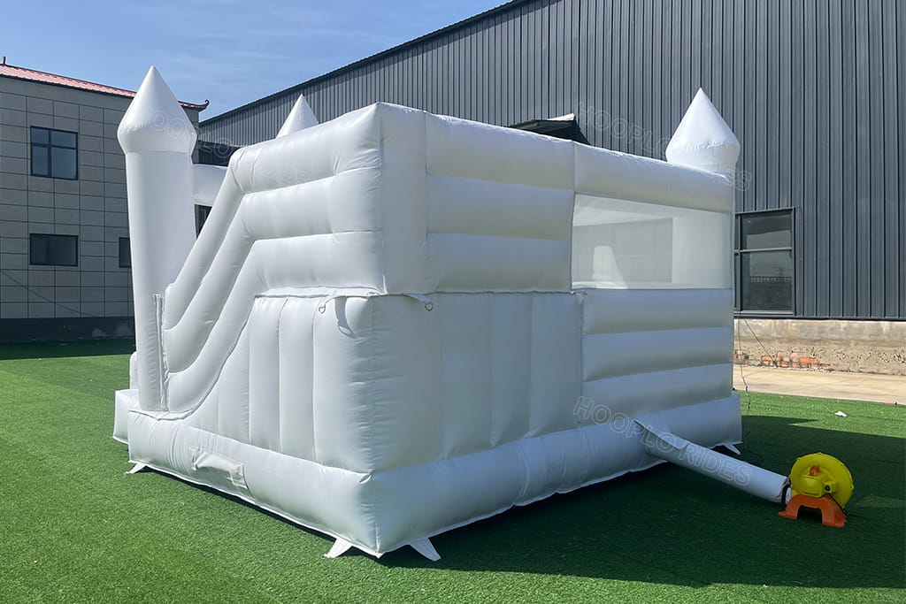 White wedding bounce house side view - All white inflatable castle with built-in slide and blower system