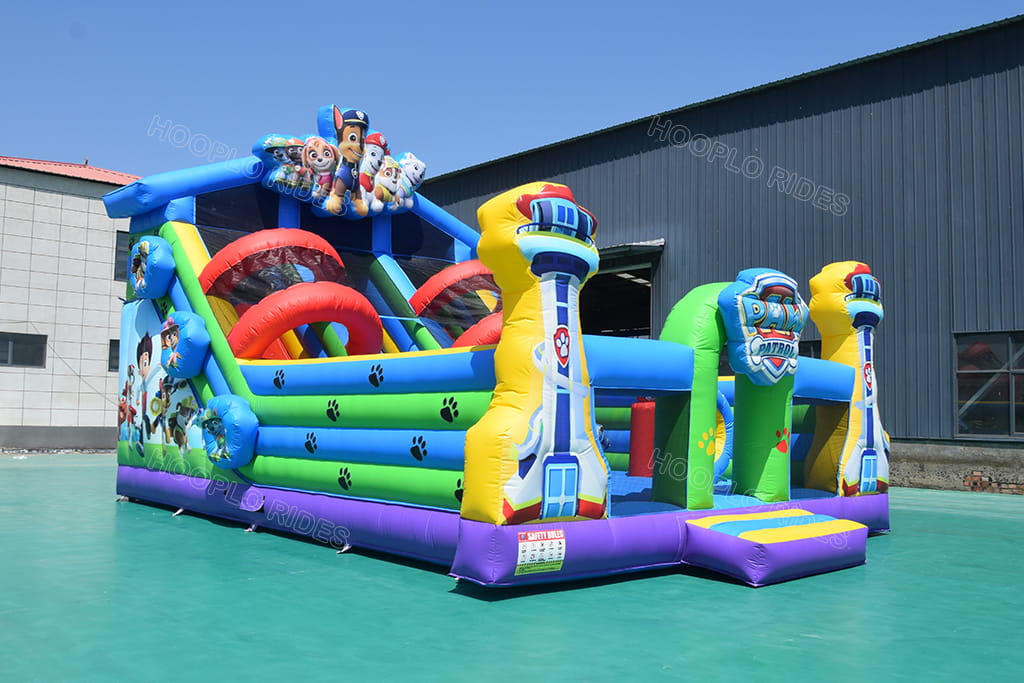 Side view of Paw Patrol inflatable obstacle playground with slide, commercial kids inflatable obstacle course with lookout tower decorations