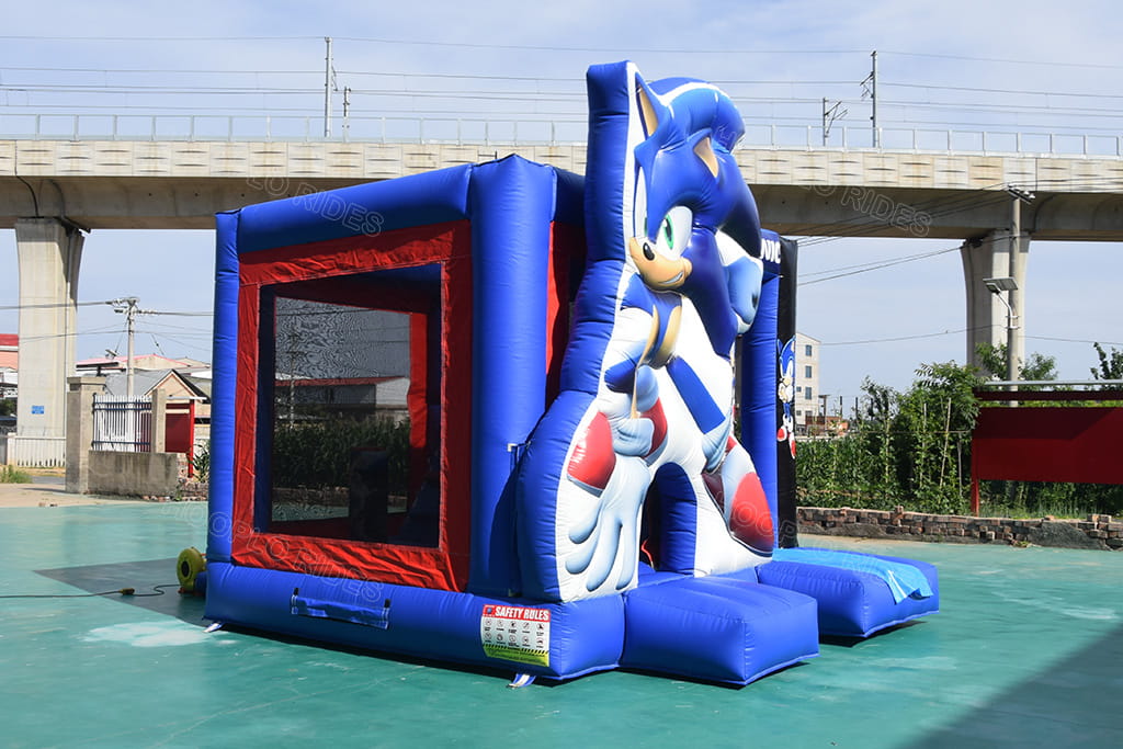 Side profile of Sonic inflatable bounce castle with big sonic hedgehog inflatable figure, safety mesh window and slide platform