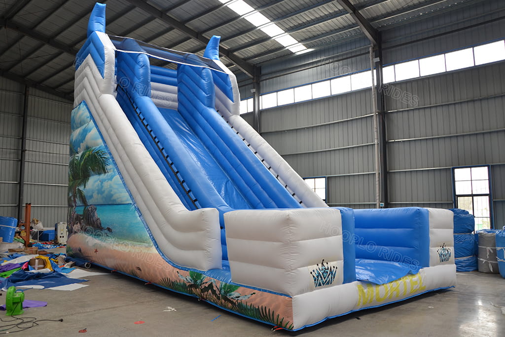 Side view of commercial beach inflatable slide with palm tree seaside digital artwork, heavy‑duty PVC