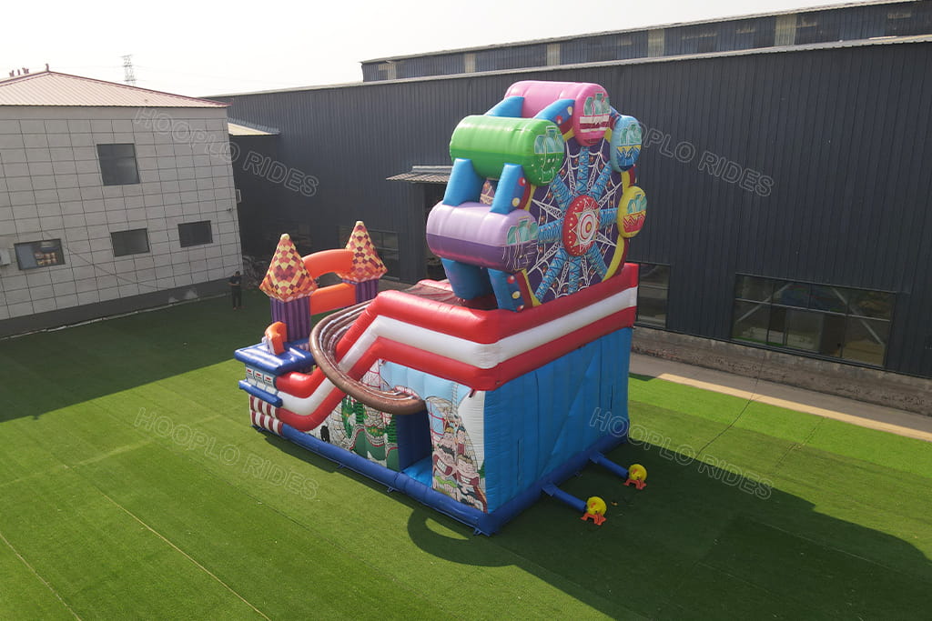 Aerial top view of carnival ferris wheel inflatable bounce house with slide, commercial amusement park inflatable castle outdoor inflation test