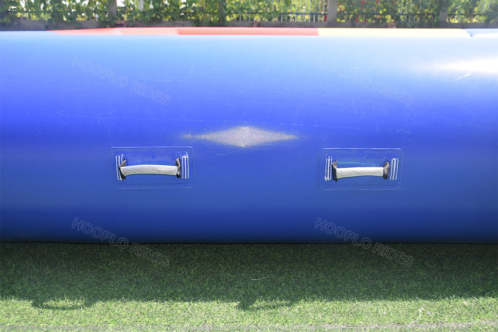 Close-up of reinforced webbing handles on commercial inflatable rectangular water pool